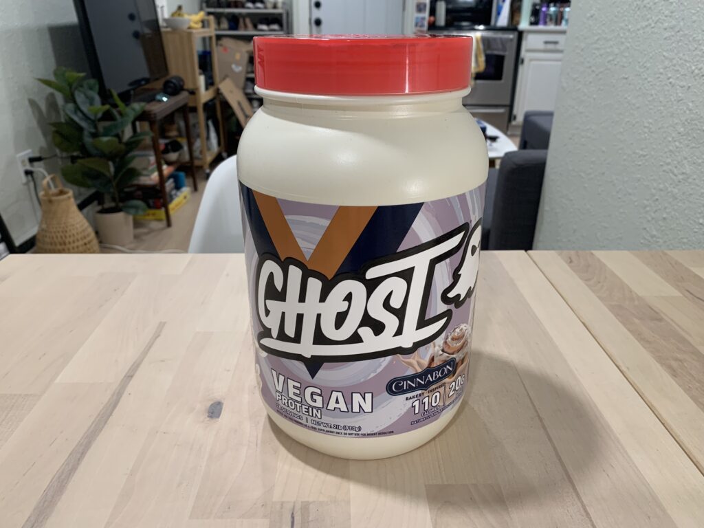 ghost vegan protein powder on table