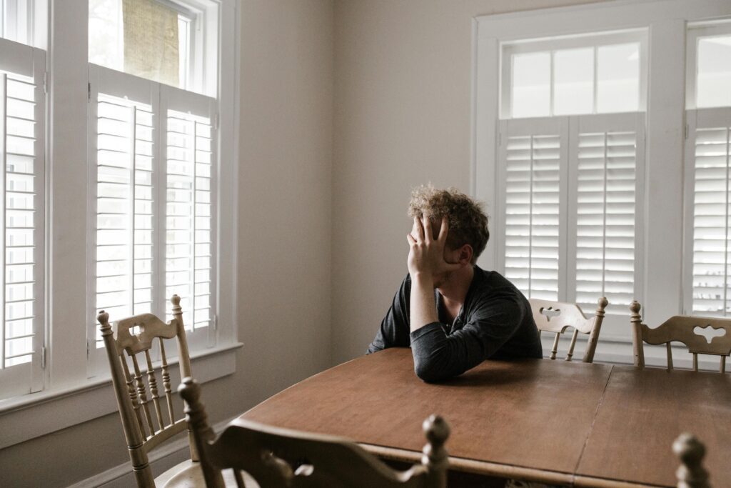  a stressed man sitting at the table